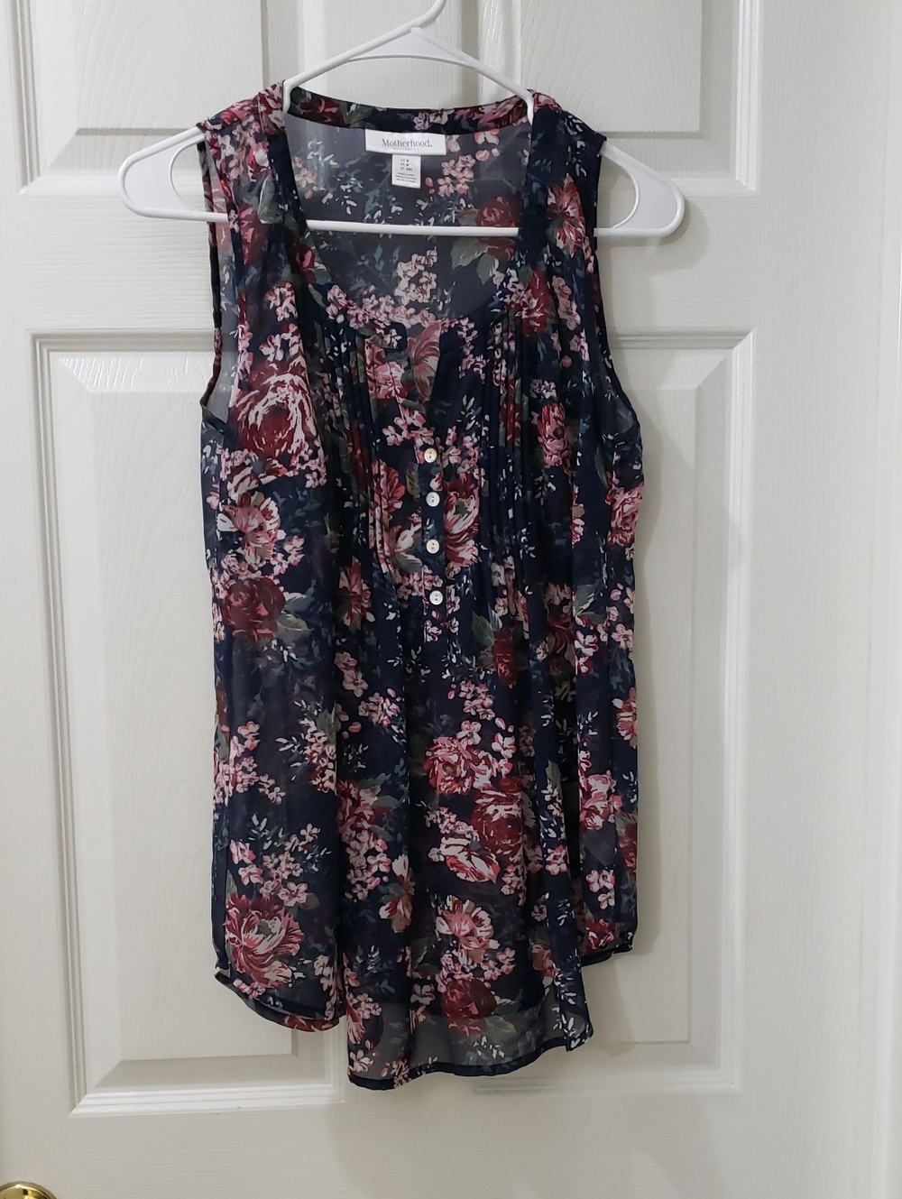 Motherhood Maternity Sheer Sleeveless Blouse In A Navy Blue And Floral Print
